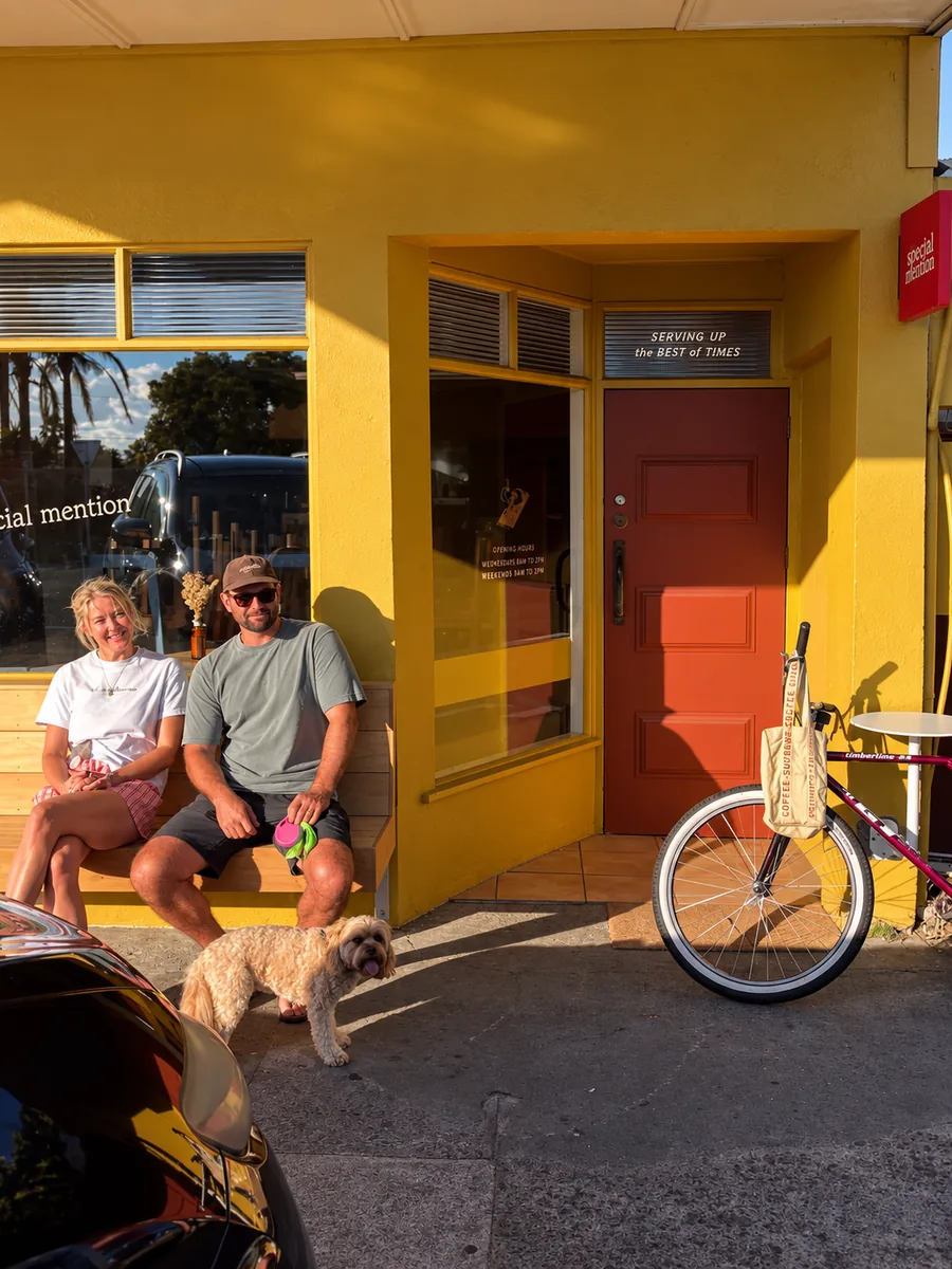Guests sitting outside the yellow entrance of Special mention cafe