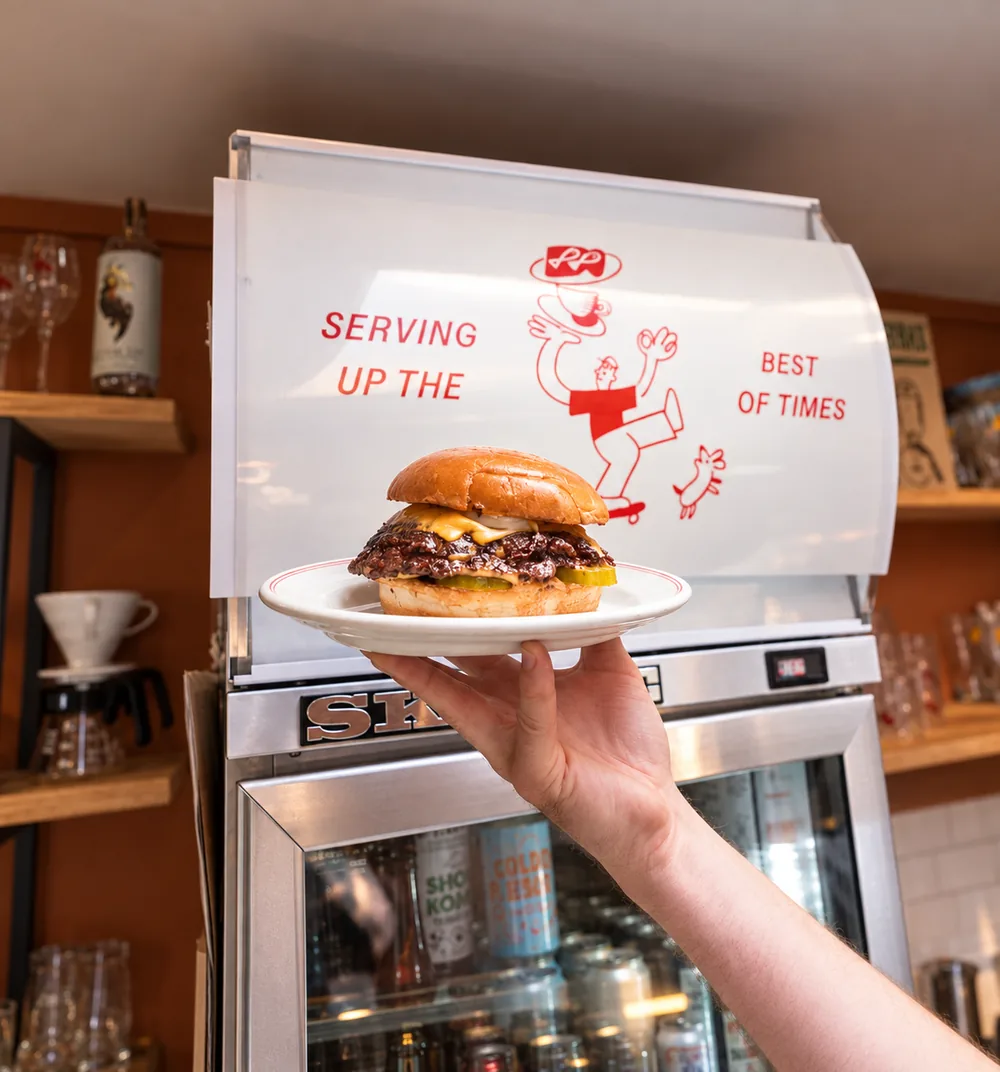 A plate being passed across the cafe counter